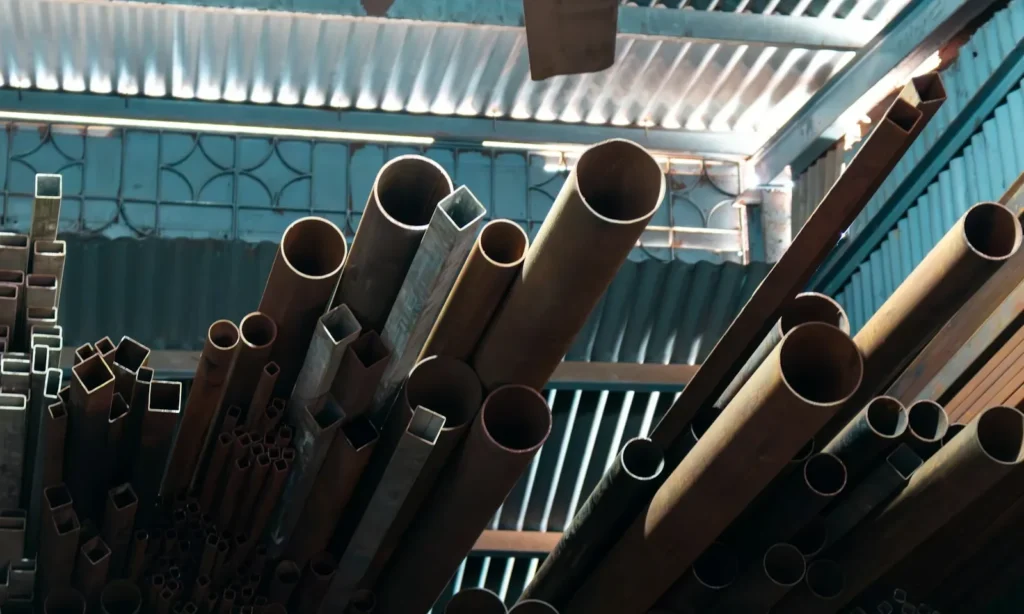 Metal pipes and tubes stacked indoors